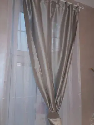 a curtain on a window in a room at Sany Center Apartment in Belgrade