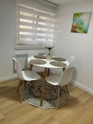 a table and chairs in a room with a window at Lily in Belgrade