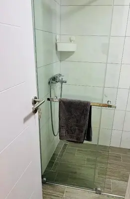 a shower with a towel on a glass door at Lily in Belgrade