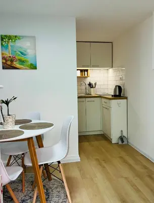 a kitchen and dining room with a table and chairs at Lily in Belgrade