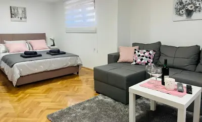 a living room with a couch and a bed at Lily in Belgrade