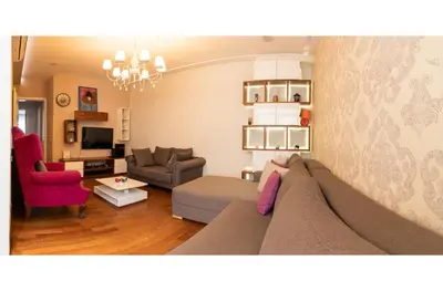 a living room with a couch and a chair at City Center Apartment in Belgrade