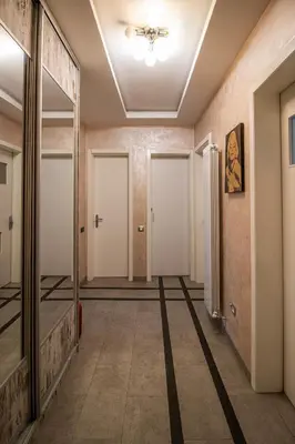 a hallway with white doors and a ceiling at City Center Apartment in Belgrade