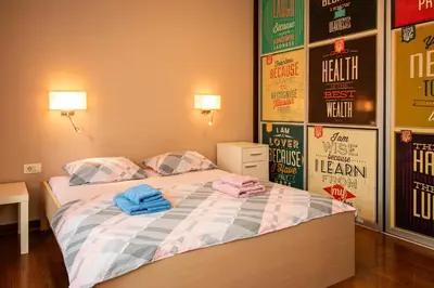 a bedroom with a bed with two towels on it at City Center Apartment in Belgrade