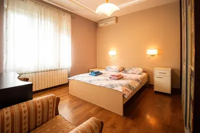 a small bedroom with a bed and a window at City Center Apartment in Belgrade