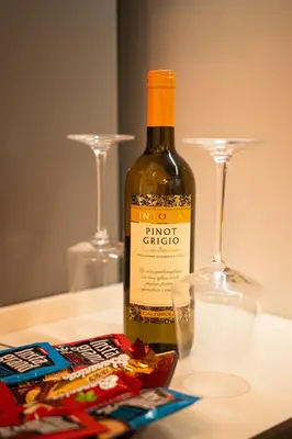 a bottle of wine sitting on a table with two glasses at City Center Apartment in Belgrade