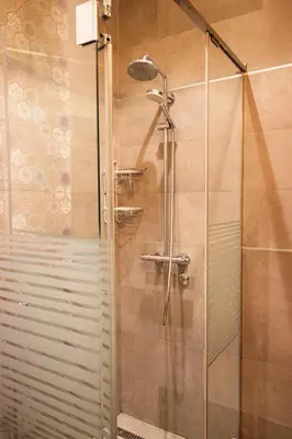a shower with a glass door in a bathroom at City Center Apartment in Belgrade