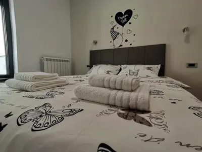 a bed with a bedspread with butterflies on it at Hill Dreams Lux in Belgrade