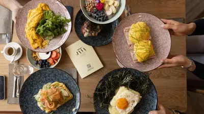 a table with plates of food on top of it at Hill Dreams Lux in Belgrade