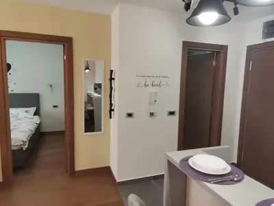 a room with a bed and a table with a mirror at Hill Dreams Lux in Belgrade