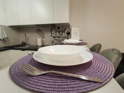a table with a plate and a fork and knife at Hill Dreams Lux in Belgrade