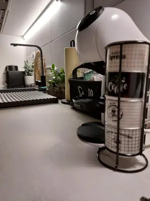 an office with a desk with a lamp and a keyboard at Bowler Hat Apartment Belgrade in Zvezdara