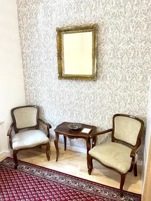 a room with two chairs and a table and a mirror at skadarlija bohemian in Belgrade