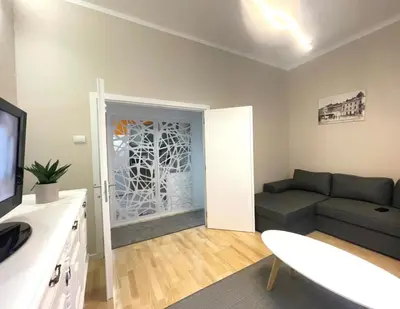 a living room with a couch and a television at skadarlija bohemian in Belgrade