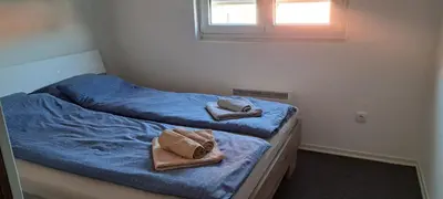 two beds with towels on them in a bedroom at Mirijevska zvezda in Belgrade