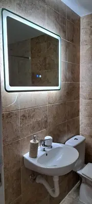 a bathroom with a sink and a mirror and a toilet at Mirijevska zvezda in Belgrade