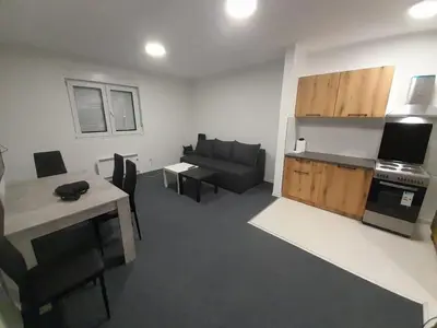 a living room with a couch and a table and a kitchen at Mirijevska zvezda in Belgrade