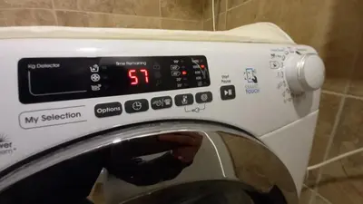 a washing machine with a clock on top of it at Mirijevska zvezda in Belgrade