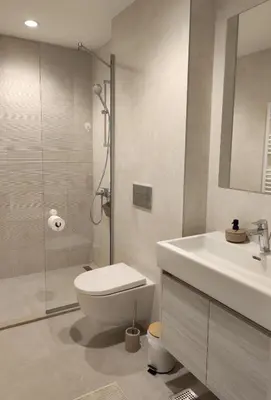 a bathroom with a toilet and a sink and a shower at Belgrade Waterfront Nabucco in Belgrade