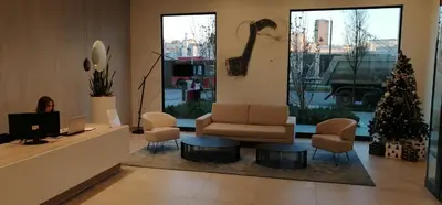 a lobby with a couch and chairs and a christmas tree at Belgrade Waterfront Nabucco in Belgrade