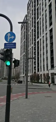a traffic light on a street with a large building at Belgrade Waterfront Carmen in Belgrade