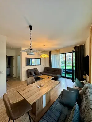a living room with a table and a couch at Belgrade Waterfront Carmen in Belgrade
