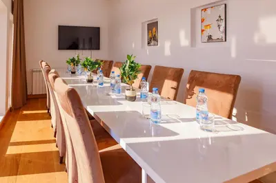 a long table with chairs and water bottles on it at Hotel AirStar in Surčin