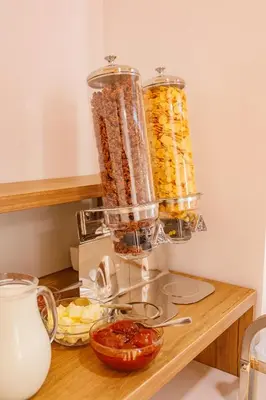 a food processor sitting on a counter with food at Hotel AirStar in Surčin