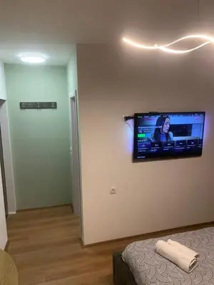 a flat screen tv on a wall in a room at Nora in Bele Vode