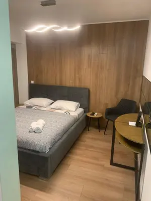 a bedroom with a bed and a table and a chair at Nora in Bele Vode