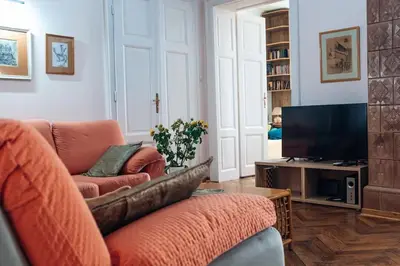 a living room with a couch and a television at Rustic Central Belgrade Stay in Belgrade
