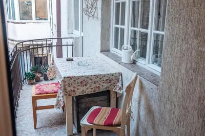 a table and chairs sitting on a balcony at Rustic Central Belgrade Stay in Belgrade