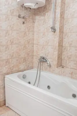 a white tub in a bathroom with a shower at Rustic Central Belgrade Stay in Belgrade