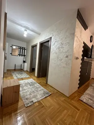 a living room with wooden floors and rugs at Port 3 in Belgrade