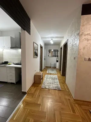 a kitchen with wooden floors and white walls at Port 3 in Belgrade