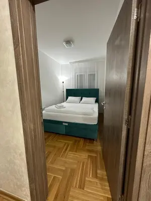 a bedroom with a bed and a wooden floor at Port 3 in Belgrade