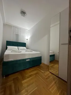 a bedroom with a bed and a mirror at Port 3 in Belgrade