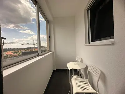a small table and chairs in a room with a window at Port 3 in Belgrade