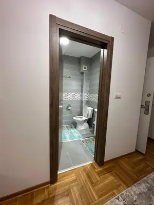 a bathroom with a toilet through a glass door at Port 3 in Belgrade
