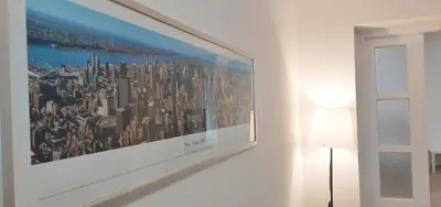 a framed picture of a city on a wall at Magenta Garden in Belgrade