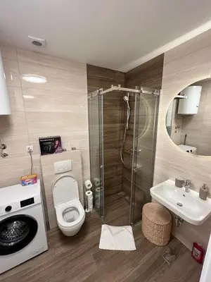 a bathroom with a shower and a toilet and a sink at Apartment Belgrade GV (free garage) in Vračar (historical)