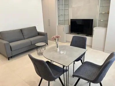 a living room with a table and chairs and a couch at Sveti Stefan in Belgrade