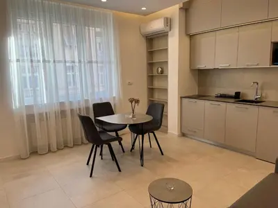 a kitchen with a table and chairs in a room at Sveti Stefan in Belgrade