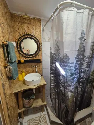 a bathroom with a shower curtain and a sink at Apartman Snežana Jugovo in Smederevo